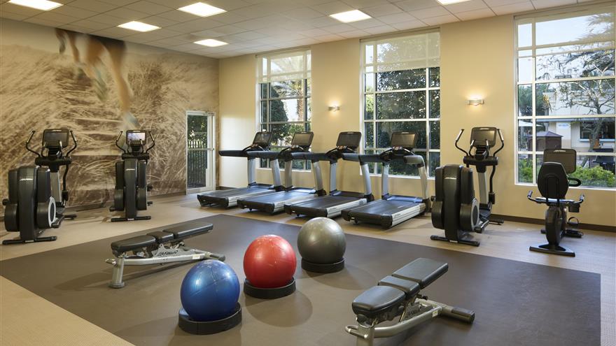 Treadmills, yoga balls, bike machines, yoga balls and benches at the gym at  Las Palmeras, a Hilton Grand Vacations Club in Orlando, Florida.