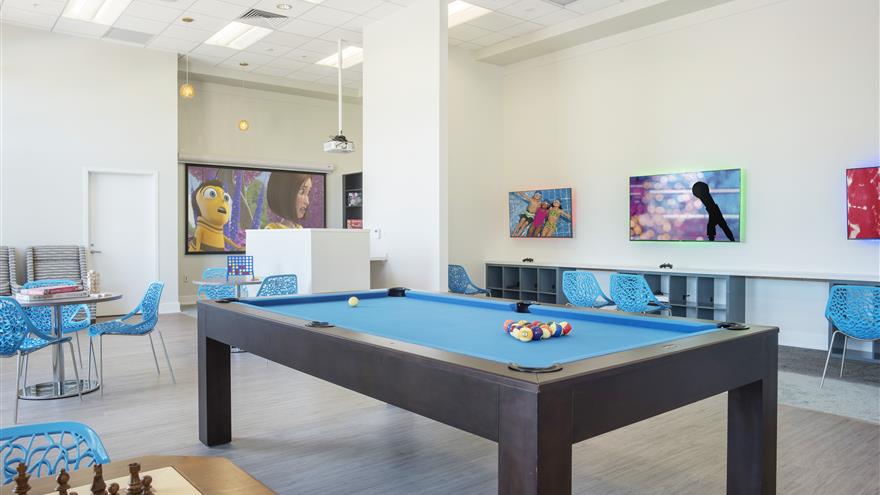 Pool table, board games and television in the Recreation Room at  Las Palmeras, a Hilton Grand Vacations Club in Orlando, Florida.