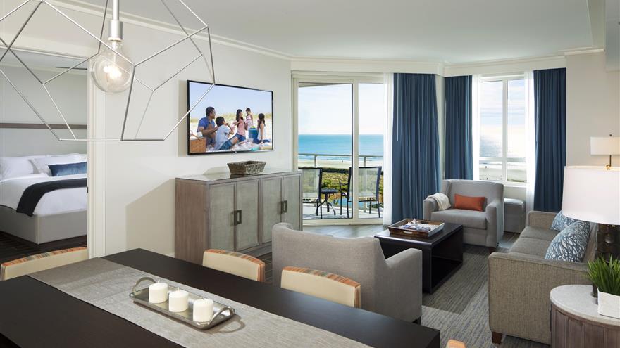 Living room with flat screen tv, sofa bed and balcony at Ocean Ocean Oak Resort, a Hilton Grand Vacations Club located at Hilton Head, South Carolina.