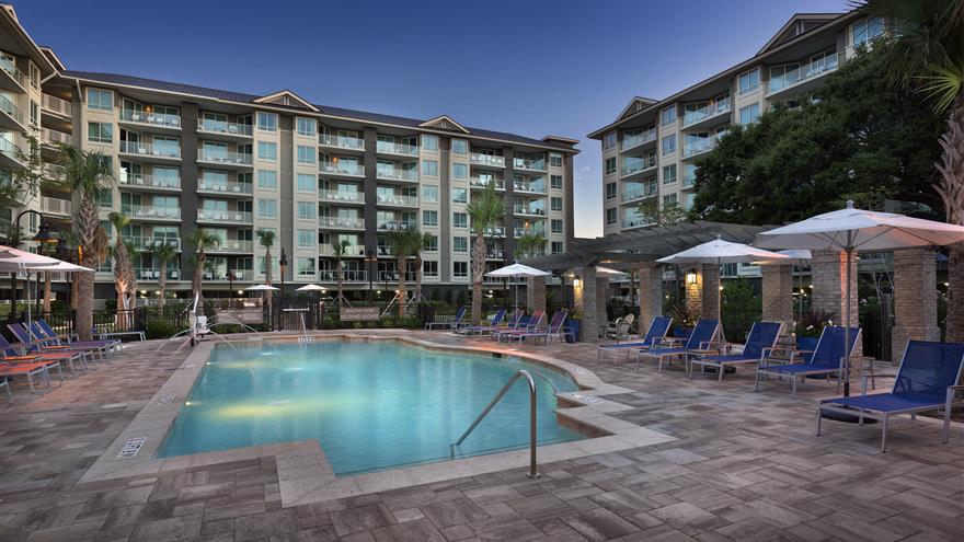The pool and courtyard illuminated as the sun set behind Ocean Oak Resort, a Hilton Grand Vacations Club located at Hilton Head, South Carolina.