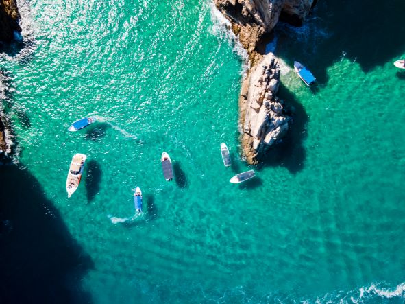 Overhead shot, boats peppered in Sea of Cortez, turquoise waters, Cabo San Lucas, Baja California Sur, Mexico.