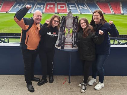 Hilton Grand Vacations Members posing, Hampden Stadium, Scotland. 