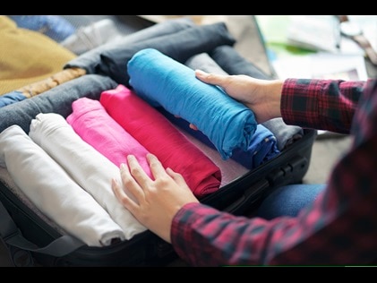 Woman packing suitcase 