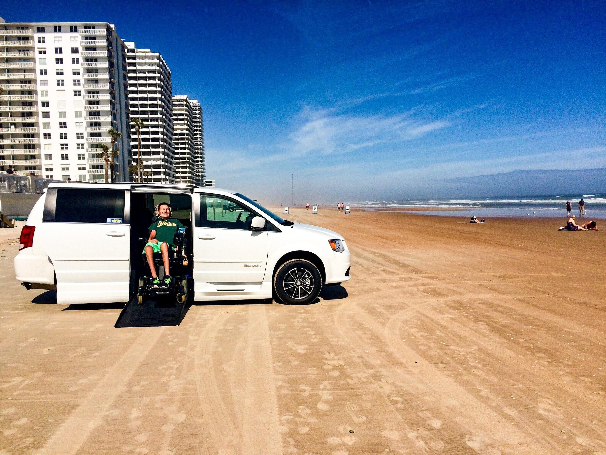 A Hilton Grand Vacations Owner parked on Daytona Beach, Florida, in his wheelchair accessible van. 