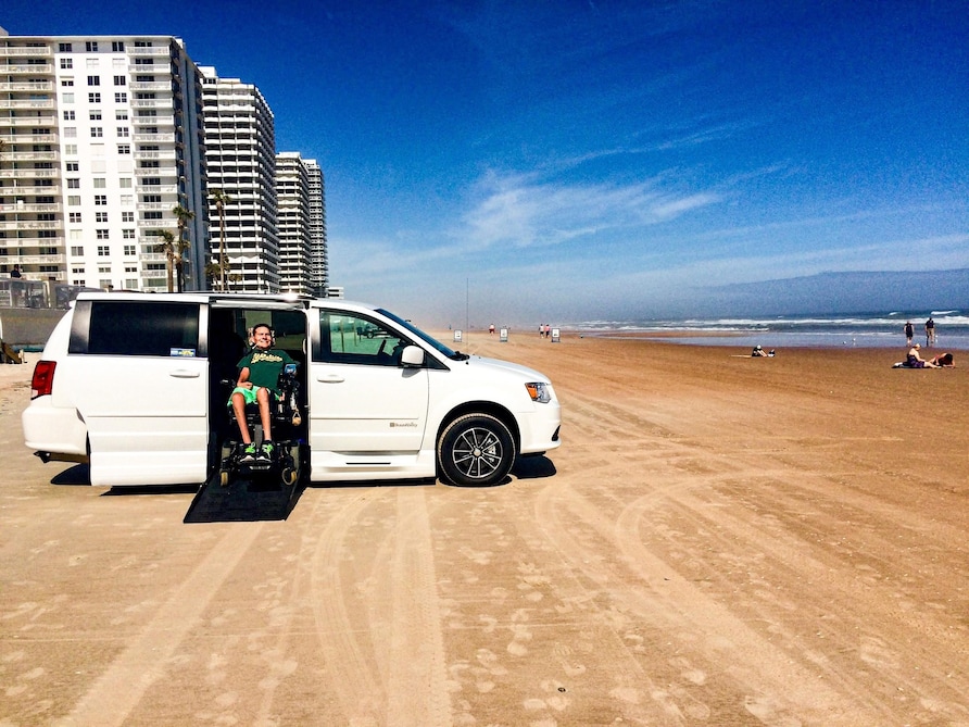 A Hilton Grand Vacations Owner parked on Daytona Beach, Florida, in his wheelchair accessible van. 