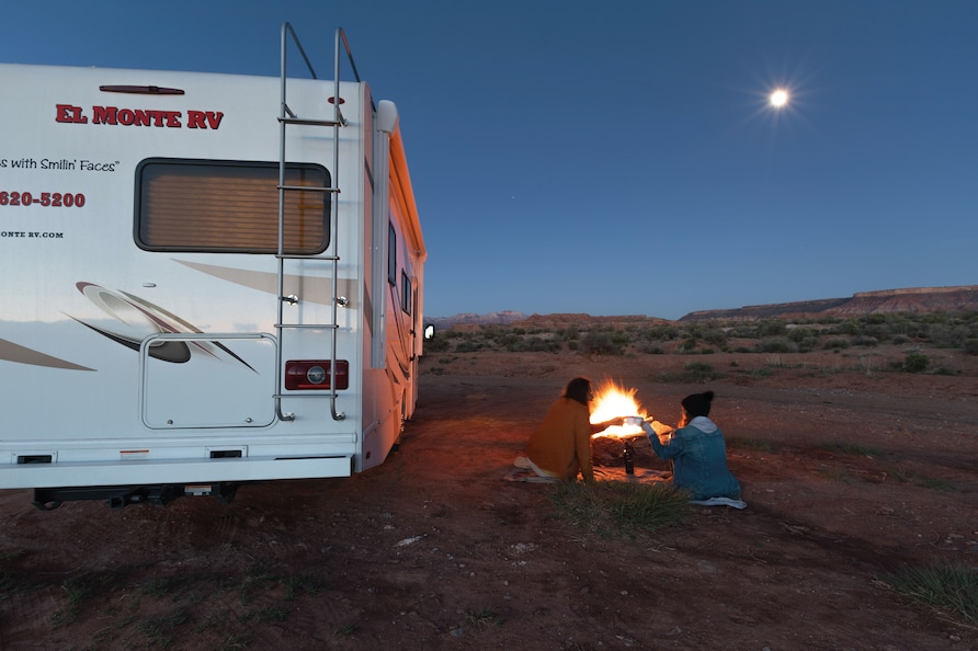 Couple making a camp fire in the desert next to El Monte RV.
