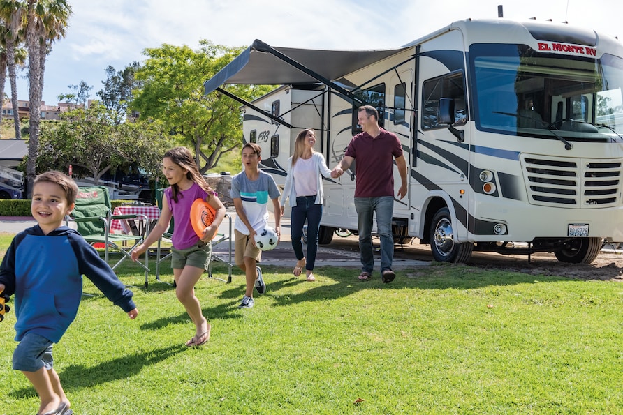Family outside El Monte RV in New Port Beach, California. 