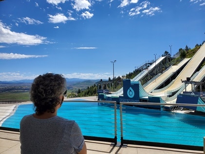 Woman admiring Olympic Park while on vacation at Sunrise Lodge, a Hilton Grand Vacations Club in Park City, Utah. 