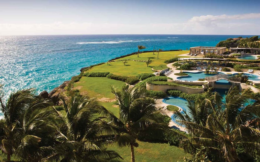 Aerial view of the pool complex overlooking the ocean at Hilton Grand Vacations at The Crane in St. Philip, Barbados. 