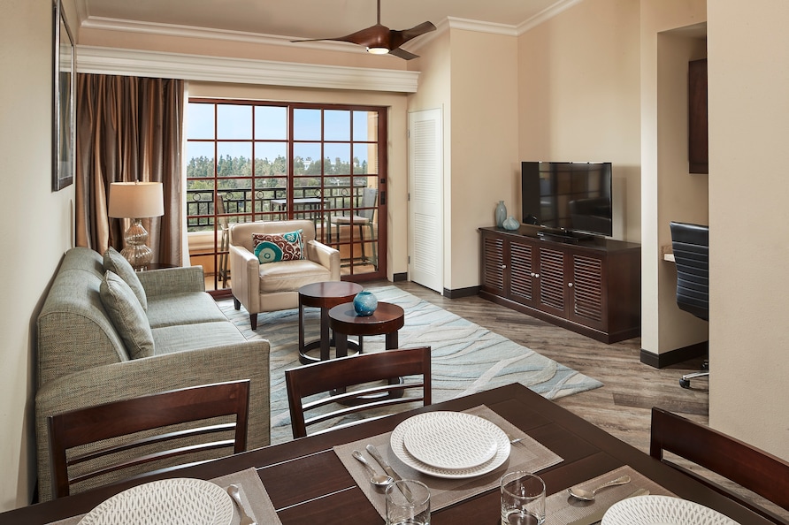 Hilton Grand Vacations suite interior, including dinning space, living room and balcony. 