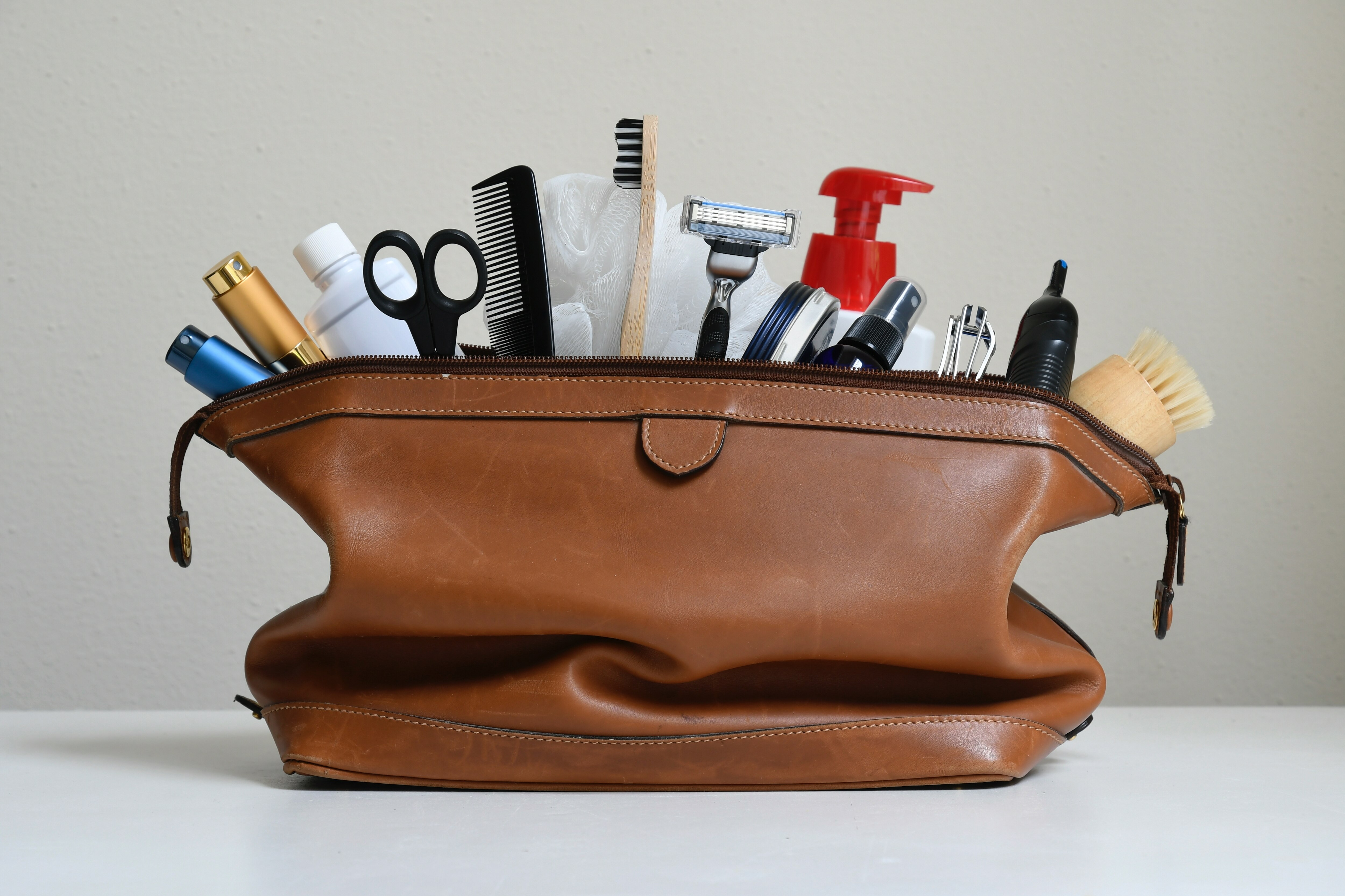 Travel toiletries in a brown travel bag. 