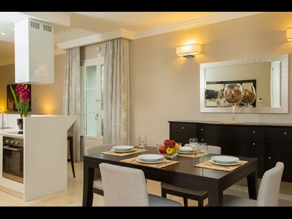 The full kitchen and dining room table in a 1-bedroom suite at Hilton Grand Vacations at Borgo alle Vigne in Tuscany, Italy. 