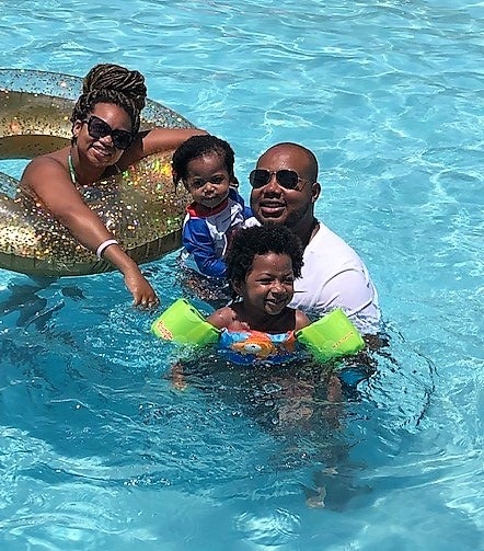 A young family floating in the pool at Ocean Oak Resort by Hilton Grand Vacations on Hilton Head Island, South Carolina. 