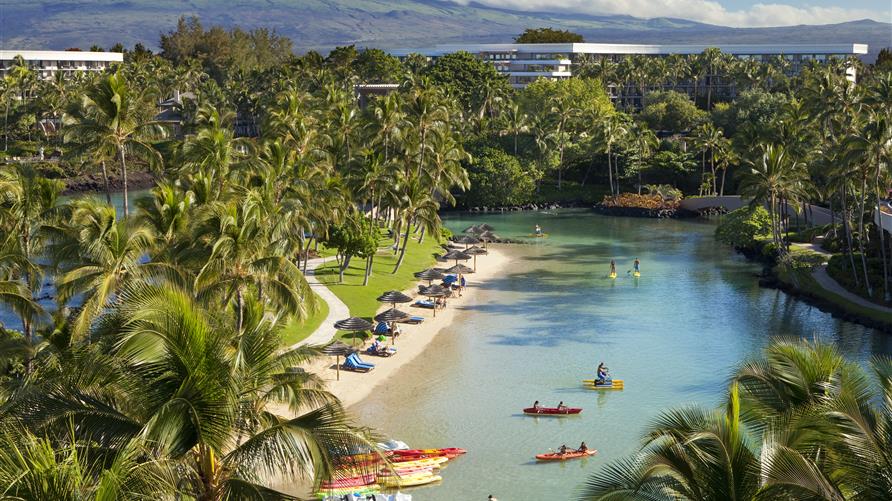 Aerial shot of travelers swimming, kayaking and enjoying Hilton Waikoloa Village's lagoon in Hawaii. 