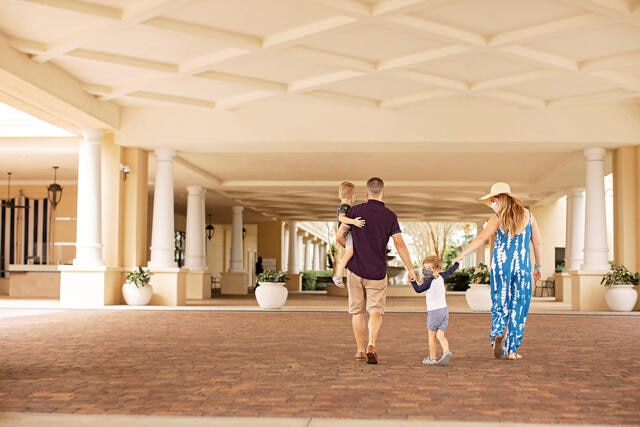 Family wearing face coverings while they arrive at Parc Soleil by Hilton Grand Vacations in Orlando, Florida.