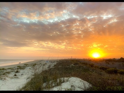 Sunset over sand dunes at Sullivan's Island Beach Charleston, South Carolina.