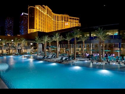 Swimming pool lit up for a night swim at Elara, a Hilton Grand Vacations Club in Las Vegas, Nevada. 
