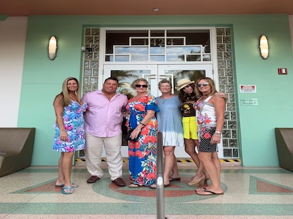 Hilton Grand Vacations Owner and wife posing with friends outside of Hilton Grand Vacations at McAlpin - Ocean Plaza.