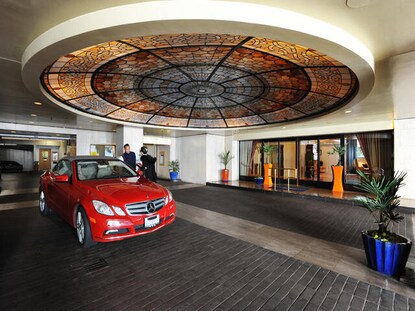 Red Mercedes rental car at the Valet at Hilton Grand Vacations exchange resort, Club Donatello in San Francisco, California.