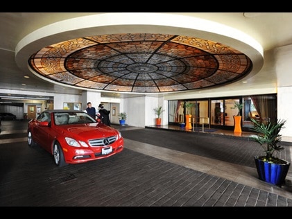 Red Mercedes rental car at the Valet at Hilton Grand Vacations exchange resort, Club Donatello in San Francisco, California.