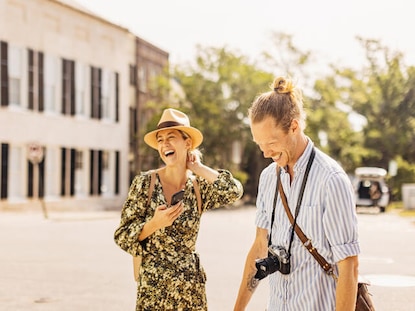 Couple laughing together while sightseeing in Charleston, South Carolina. 