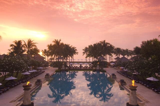 Pink painted skies over the pool at Hilton Conrad in Bali.