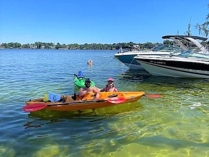 Hilton Grand Vacations Explorers posing with kayaks in Butler Chain of Lakes, Central Florida. 