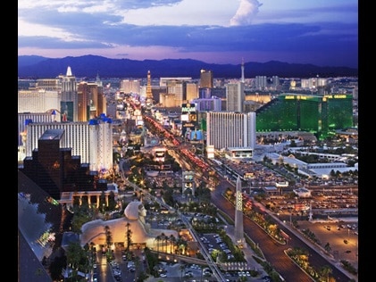Aerial view of the Las Vegas Strip with purple painted skies overhead. 