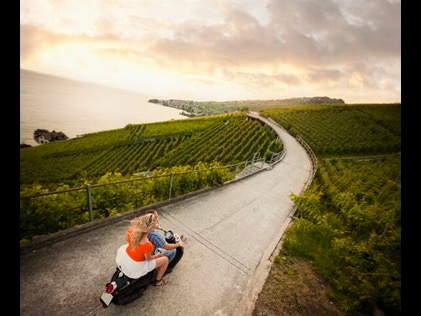 Aerial shot of a couple riding a scooter along a country road in Tuscany, Italy. 