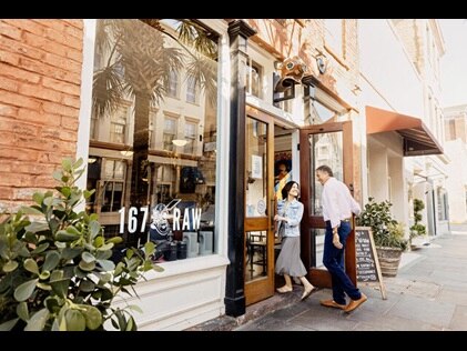 Couple walking into restaurant in Charleston, South Carolina. 