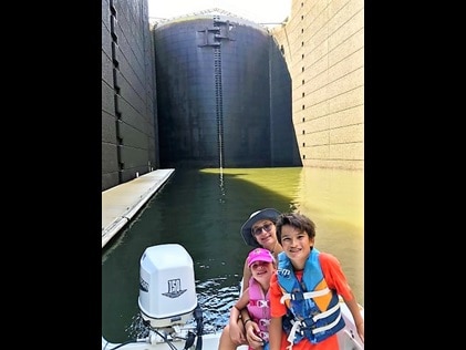 Kids in a boat posing at Pinopolis Locks in Charleston, South Carolina. 