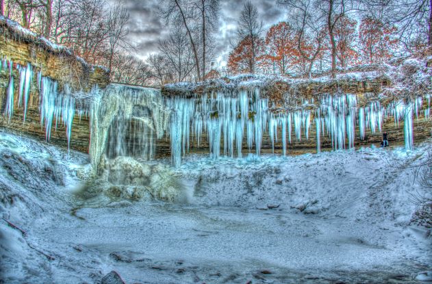 Stunning shot of Minnehaha Falls frozen into a wall of ice during winter, Minnesota.