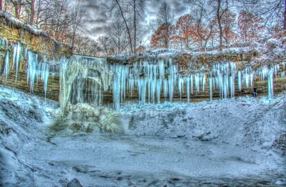 Stunning shot of Minnehaha Falls frozen into a wall of ice during winter, Minnesota. 