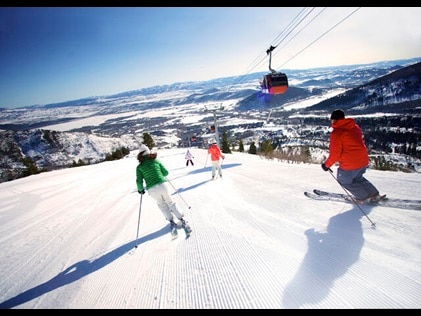 Downhill skiers enjoy fresh powder in Breckenridge, Colorado.