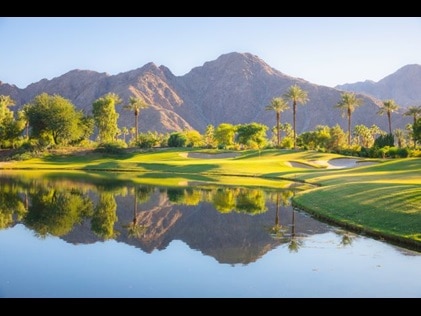 Meticulous golf course with lake and mountains in the distance, Palm Springs, California.