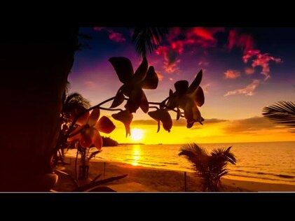 Stunning sunset shot through tropical flowers overlooking the ocean, Mexico. 