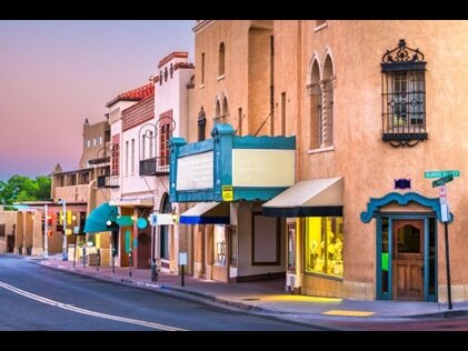 Colorful Santa Fe storefronts with purple sunset skies overhead, New Mexico.