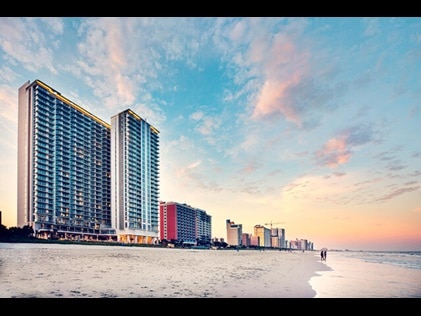 Exterior shot of Ocean 22 by Hilton Grand Vacations with cotton candy sunset skies overhead, Myrtle Beach. 