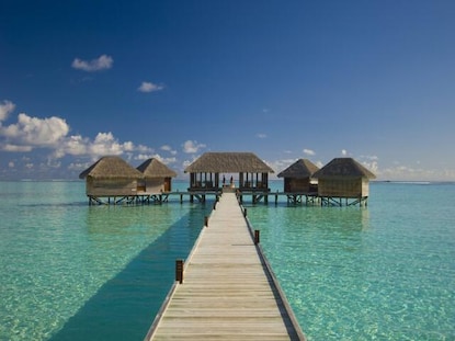 Idyllic shot of overwater walkway leading to overwater bungalows, Conrad Maldives Rangali Island.