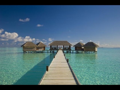 Idyllic shot of overwater walkway leading to overwater bungalows, Conrad Maldives Rangali Island.