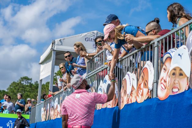 Shot of celebrity interacting with spectators in the stands at Hilton Grand Vacations Tournament of Champions.