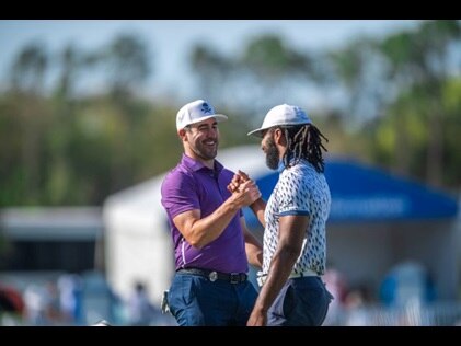Celebrities at Hilton Grand Vacations Tournament of Champions smiling and giving fist bump on the green.
