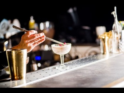 Shot of mixologist making craft cocktail. 