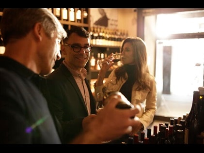 Group of friends sampling wine.