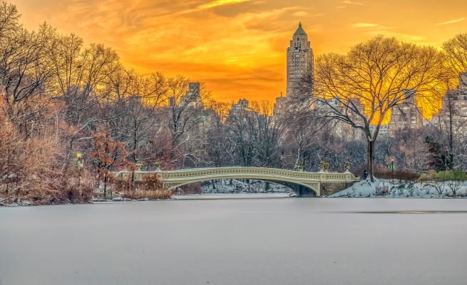 Picturesque snow covered winter pananorama against the glowing sunrise sky, New York.