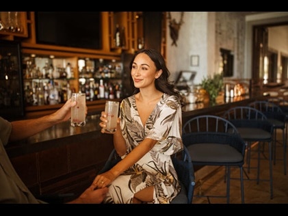 Attractive woman enjoying at cocktail at a bar.