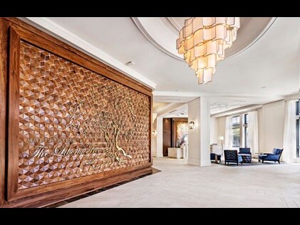 Liberty Place Charleston by Hilton Club lobby displaying a wooden plaque with brass replica of the Liberty Tree. 