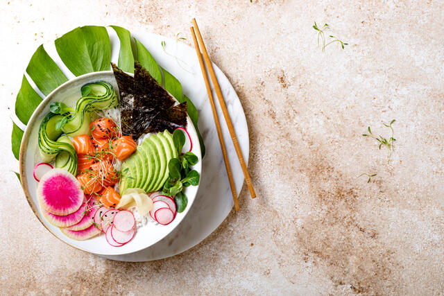 Overhead shot of colorful and beautifully plated poke bowl.