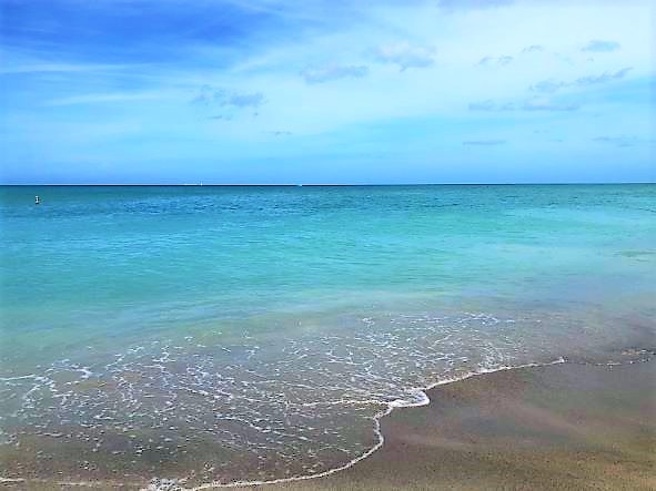 Beautiful shot of blue water washing ashore, Melbourne Beach, Florida.