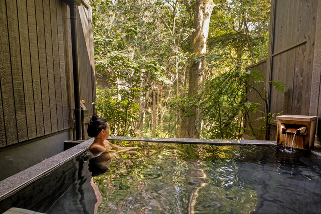 Woman soaking in hot springs at The Bay Forest Odawara, a Hilton Club, Japan.